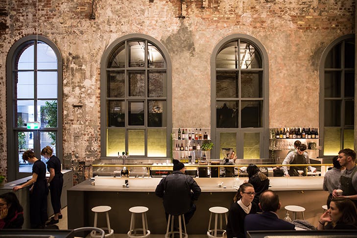 The interior of Higher Ground. Exposed bricks line the walls.